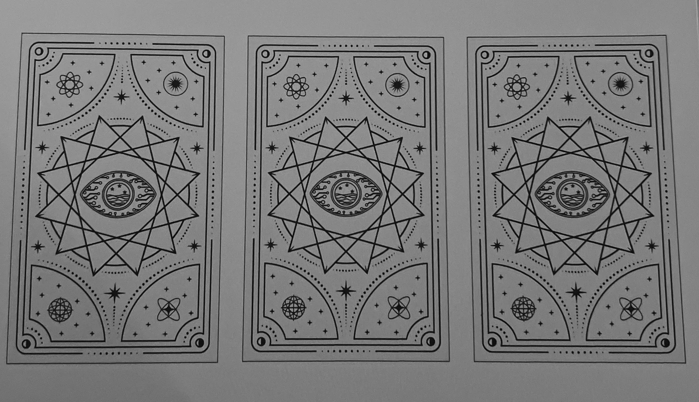 Early printed card-back prototype with decorative black patterns.