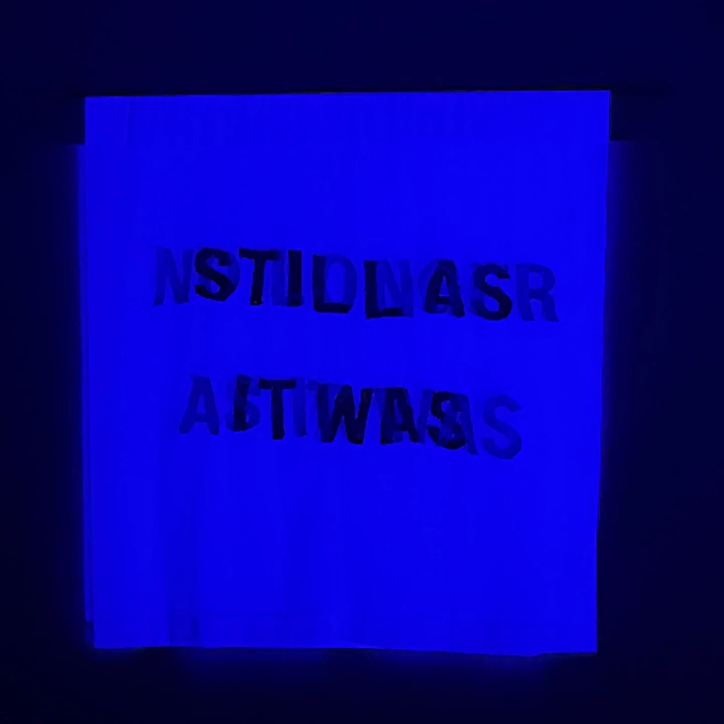 Blue light: Blue projected light changes which stitched letterforms can be read.